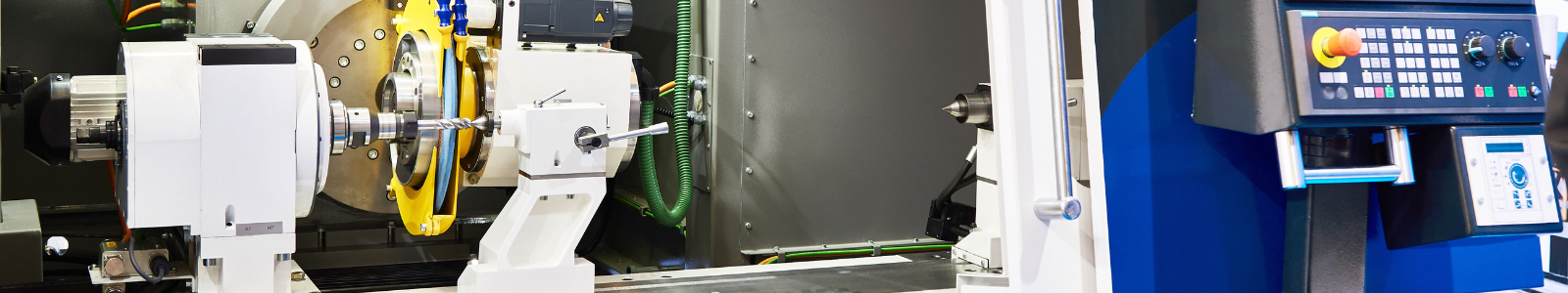 IN_MT_CNC-grinding-machine-shutterstock_1600x200 - 1 Close iup image of CNC machine tool ast 1600x200 dimensions.